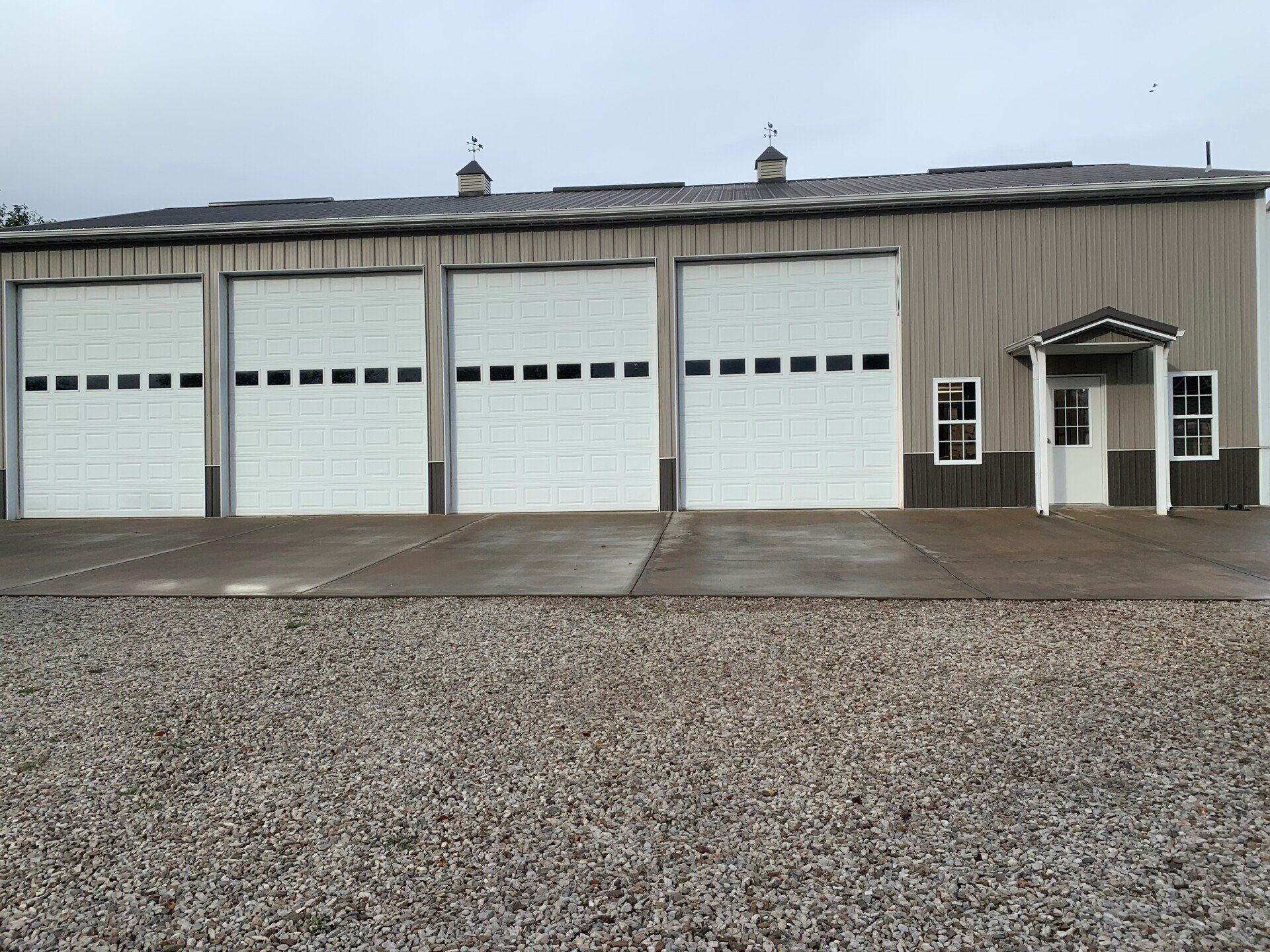 A row of garage doors are lined up in front of a building