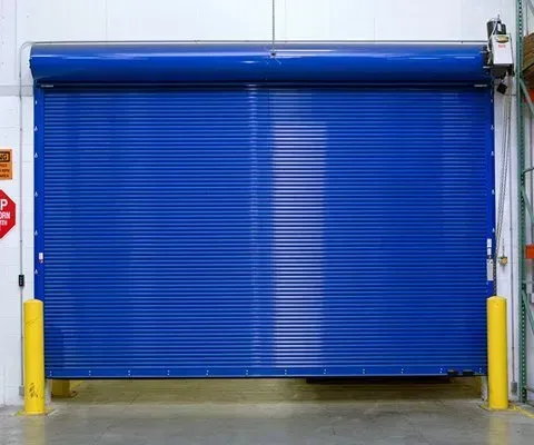 Blue rolling security door, horizontal metal slats, closed, warehouse interior.