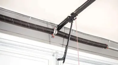 Garage door opener system with a spring and track.