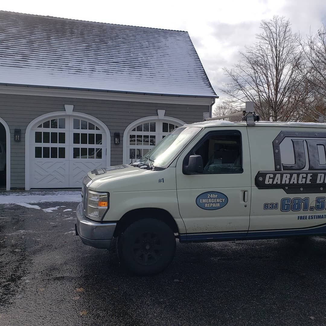 Two Aperol spritzes in tall glasses with straws, on a weathered wooden table.