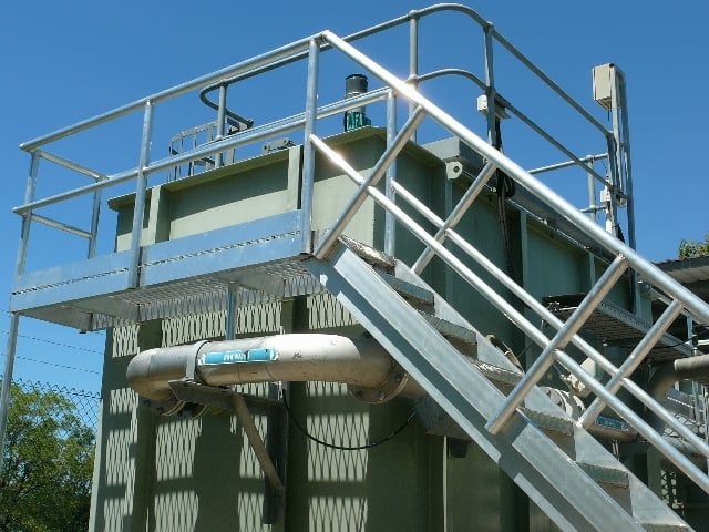 Industrial Metal Stairway and Platform Beside a Corrugated Structure — Greville Fabrication in Girraween, NSW