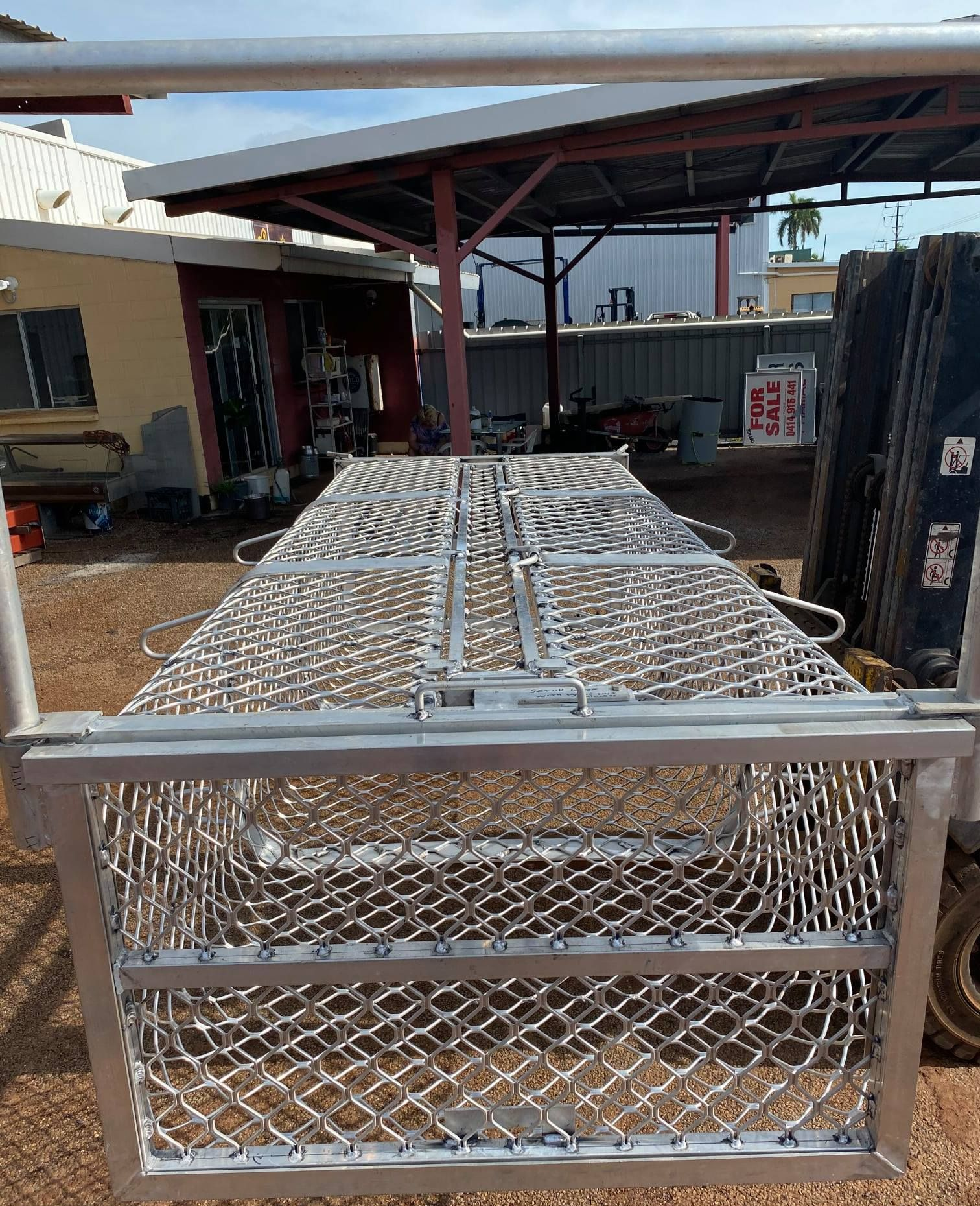 Metal Mesh Crate on a Forklift in an Industrial Yard Under a Covered Shed — Greville Fabrication in Girraween, NSW
