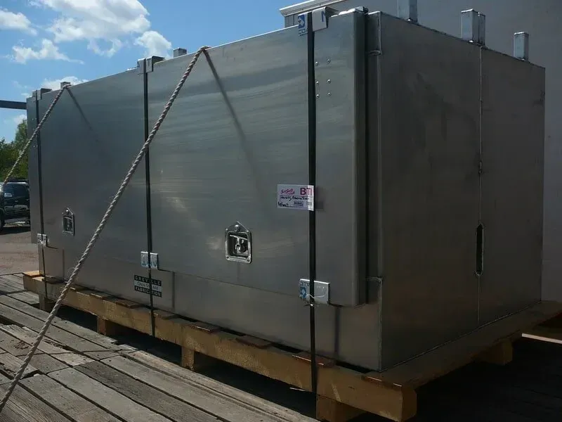 Large, Metal Container Secured to a Wooden Pallet With Straps — Greville Fabrication in Girraween, NSW