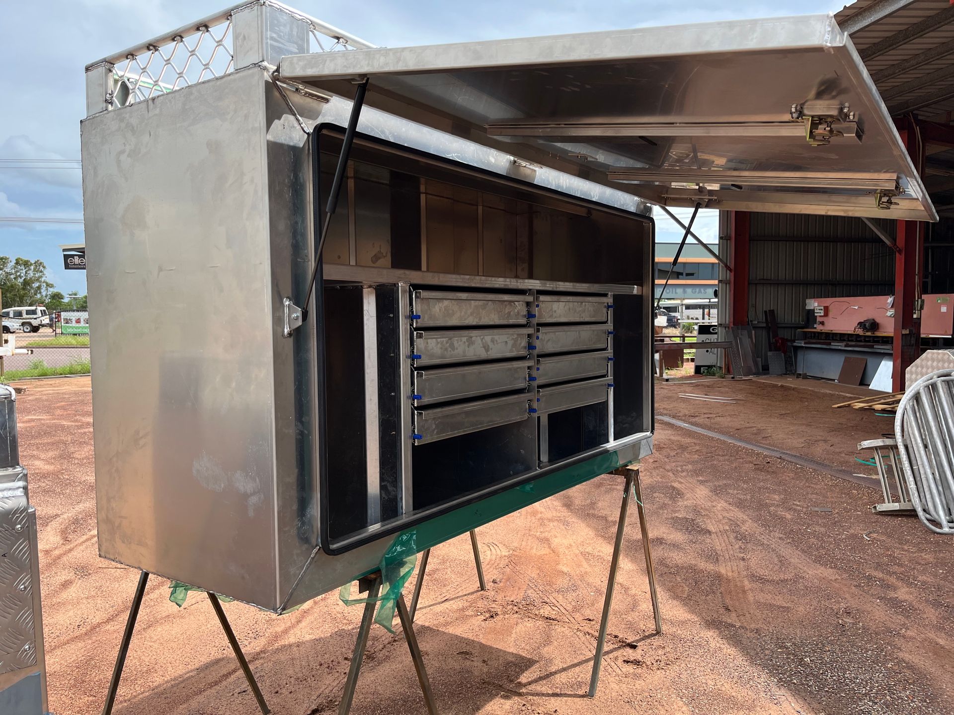 Open Trailer-mounted Metal Grill With Drawers, Parked on Dirt Ground Outdoors — Greville Fabrication in Girraween, NSW
