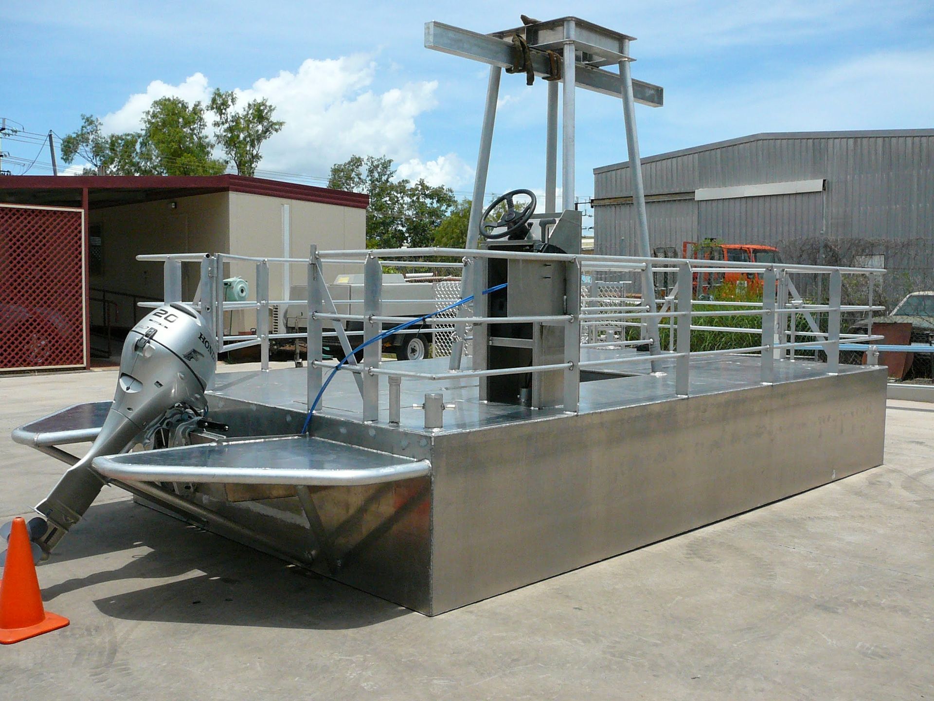 Small Metal Workboat or Barge With Equipment, Docked Beside a Building in a Yard — Greville Fabrication in Girraween, NSW