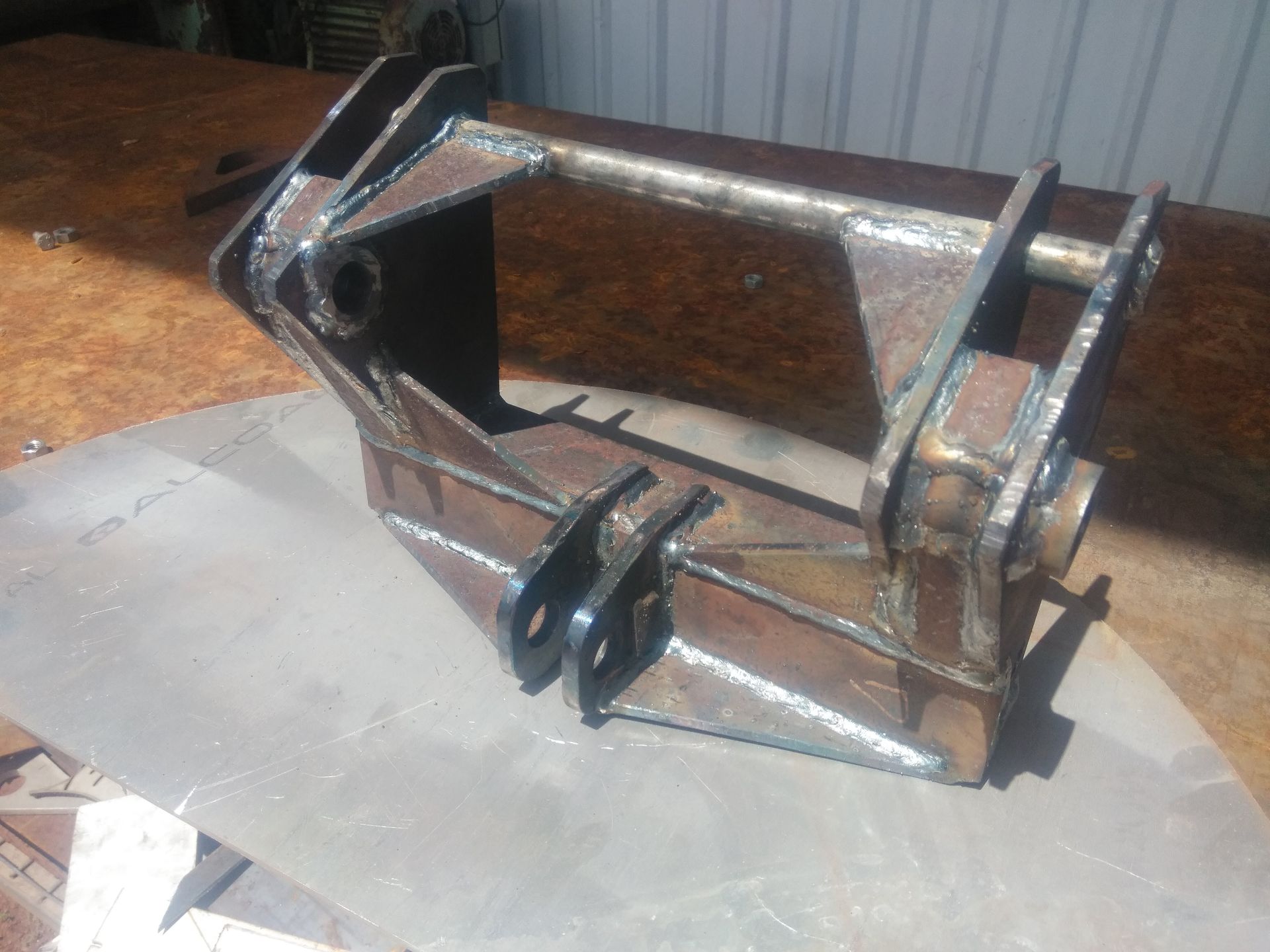 Rusty Metal Excavator Bucket Attachment on a Workbench in a Workshop — Greville Fabrication in Girraween, NSW