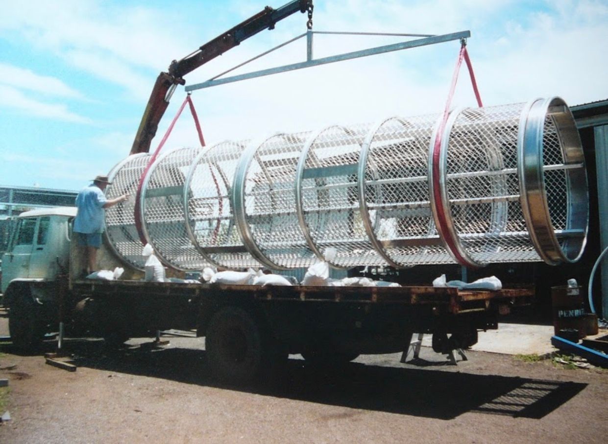 Large Cylindrical Metal Structure Being Unloaded From a Truck by a Crane — Greville Fabrication in Girraween, NSW