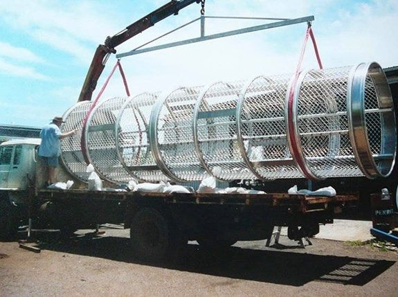 Metal Crocodile Cage Being Lifter Onto A Truck With A Crane — Greville Fabrication in Girraween, NSW