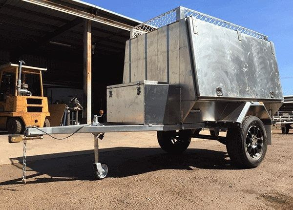 Silver Camping Trailer With Black Wheels Parked Outdoors — Greville Fabrication in Girraween, NSW