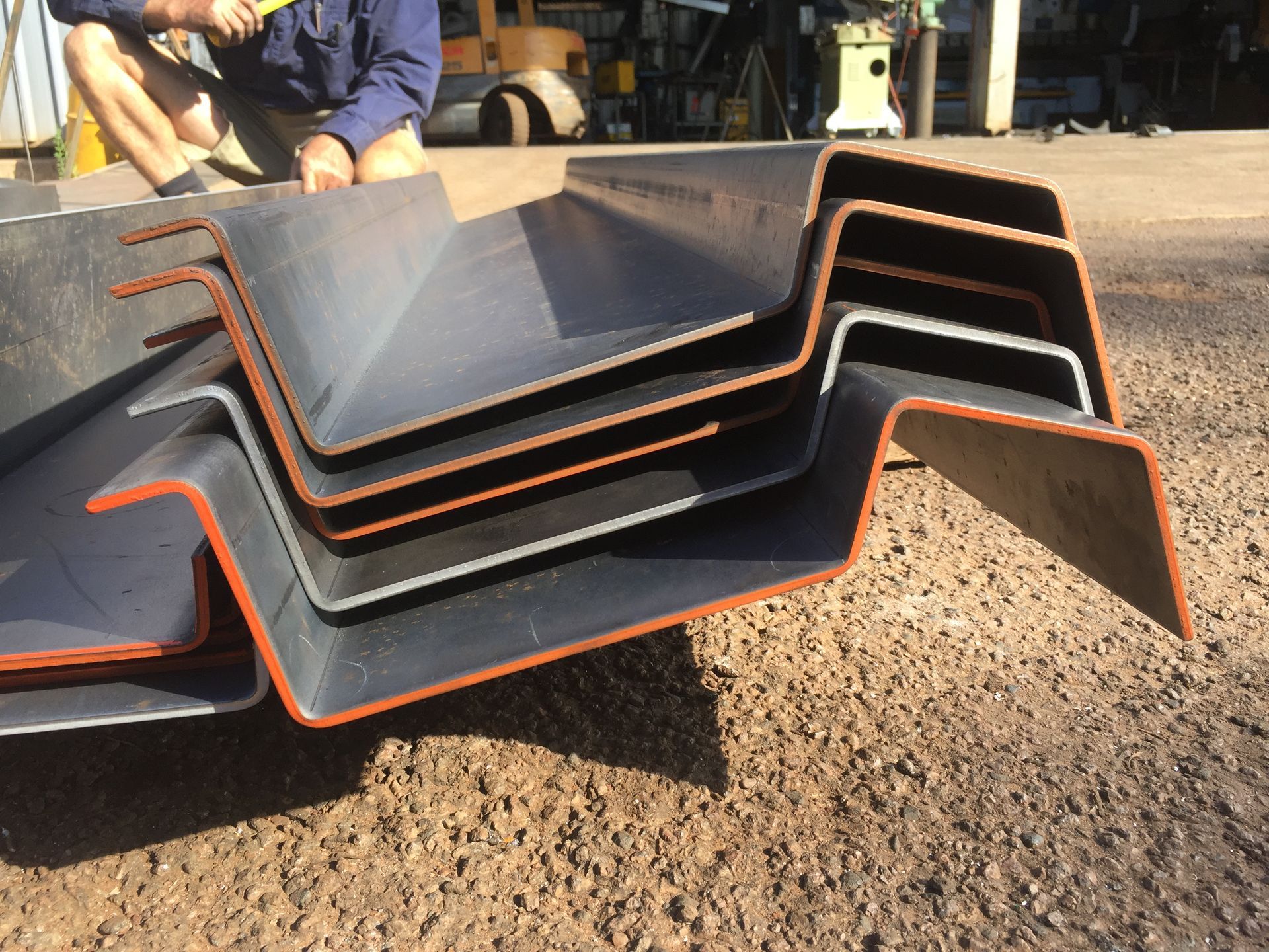 Stacked Black Metal Ramps With Orange Edges on Gravel Outdoors — Greville Fabrication in Girraween, NSW