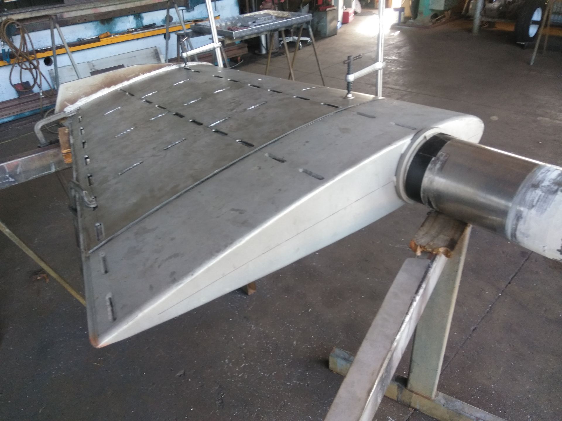 Metal Aircraft Wing Section in a Workshop, Shown Attached to a Cylindrical Tube — Greville Fabrication in Girraween, NSW