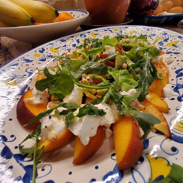 A blue and white plate with a salad on it