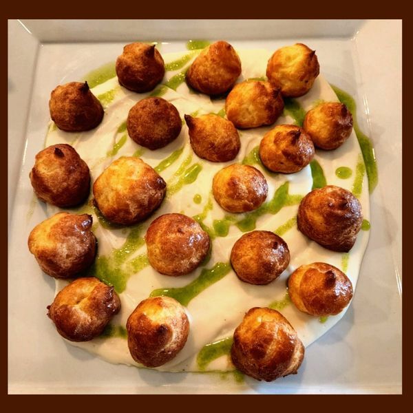 A plate of food with a green sauce on it