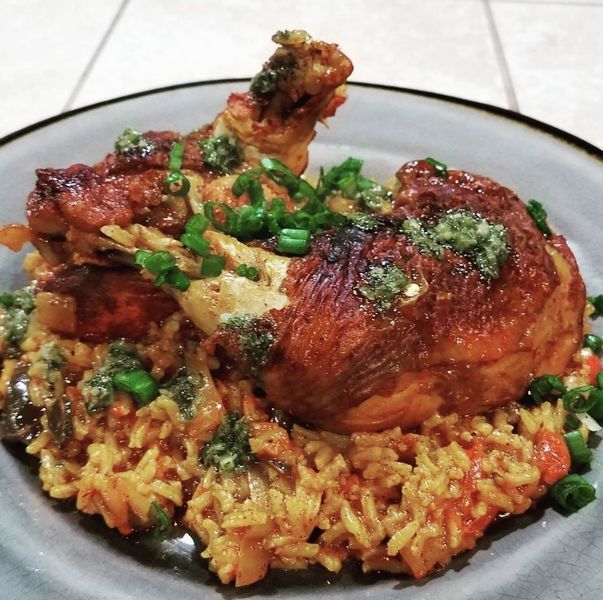 A plate of food with rice and chicken on it