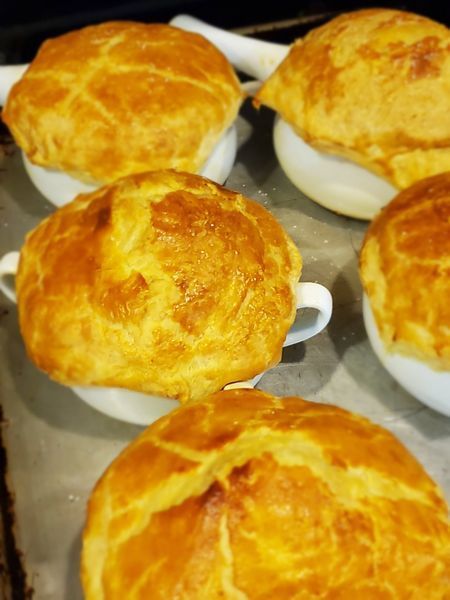 A bunch of pot pies are sitting on a table