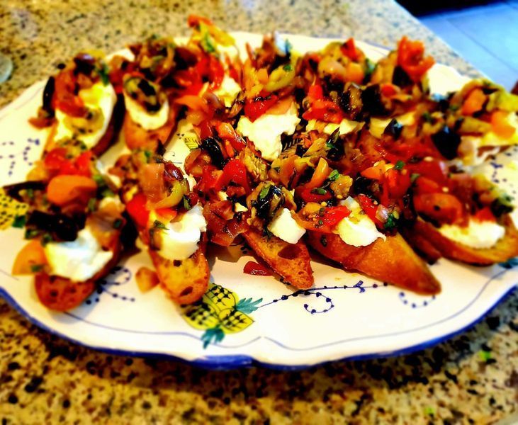 A plate of food with vegetables and cheese on a table