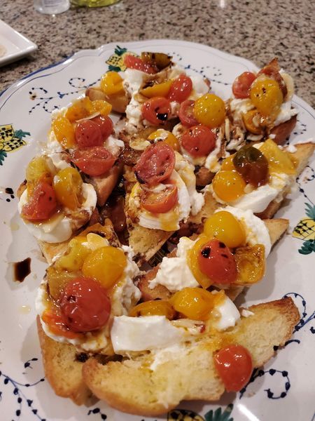 A plate of food with tomatoes and cheese on it