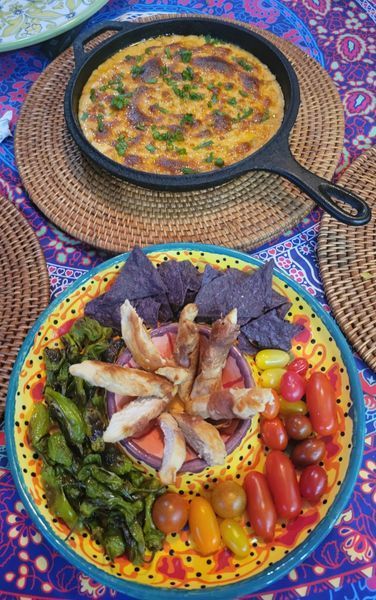 A table topped with plates of food and a skillet of food.
