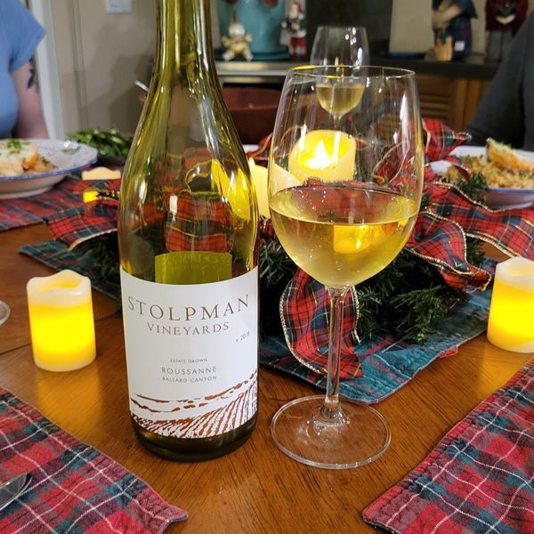 A bottle of stolpman vineyards wine sits on a table
