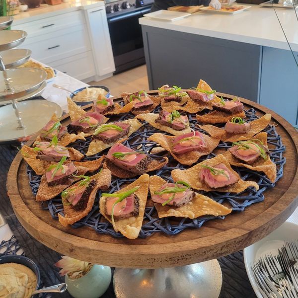 A wooden tray filled with food on a table