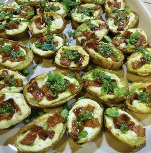 A tray of appetizers with cheese bacon and green onions