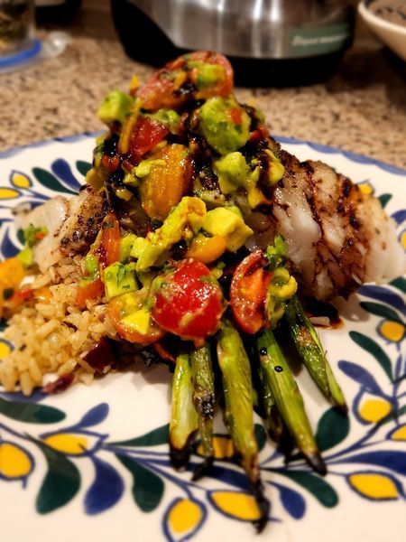A plate of food with rice and vegetables on a table