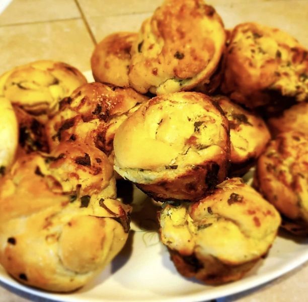 A white plate topped with a bunch of muffins