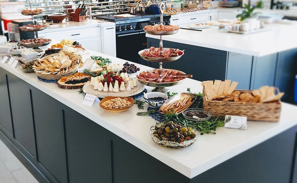 A buffet table with a variety of food on it.