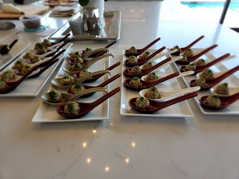 A table topped with plates and spoons filled with food