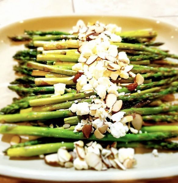 Asparagus with almonds and cheese on a plate