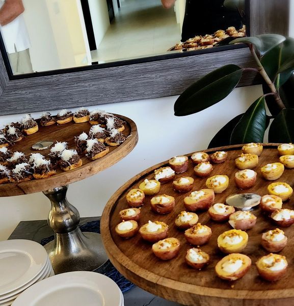A wooden tray with a lot of food on it