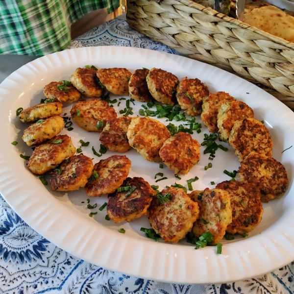 A plate of food on a table with a basket in the background