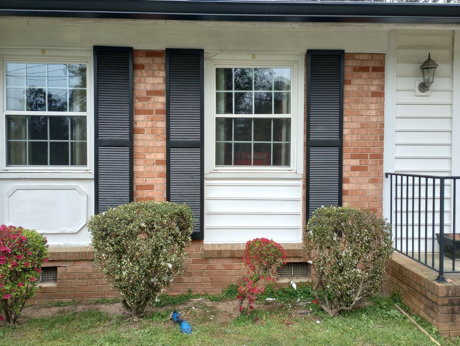Wood rot replaced with vinyl siding on right window; left window in progress