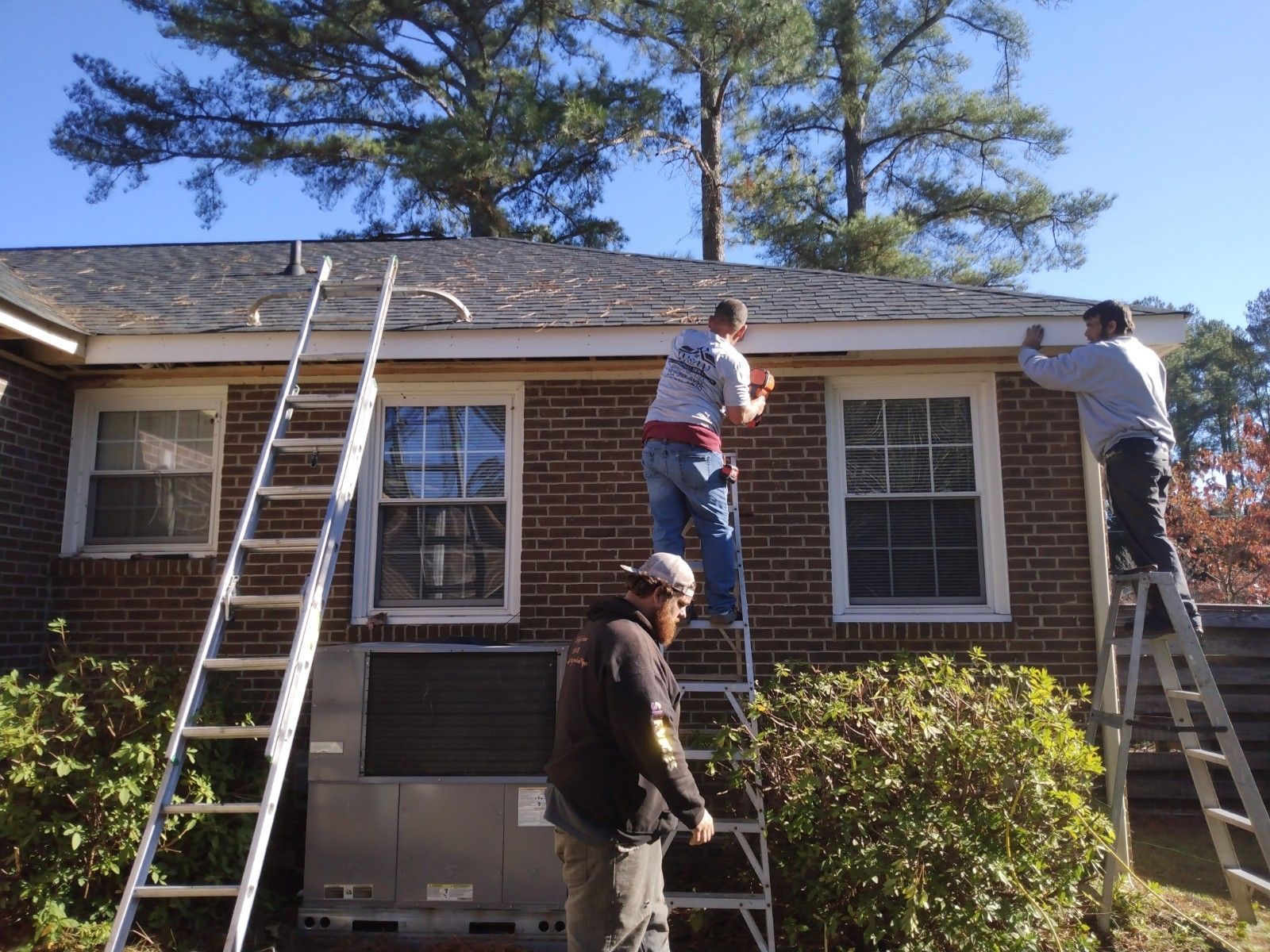 Workers replacing the wood rot