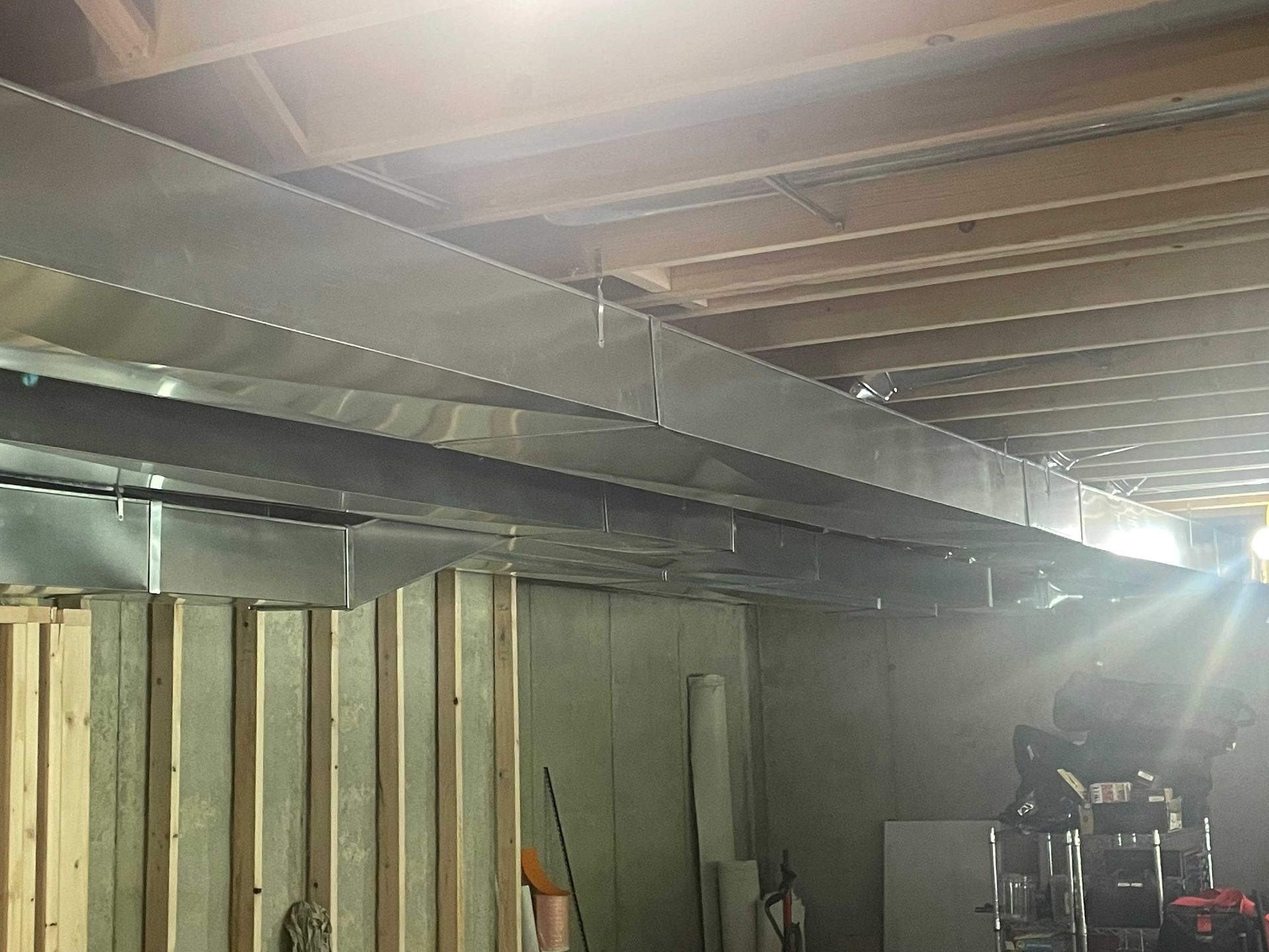 A room with a lot of wooden beams and a ceiling.