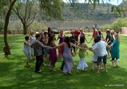 A group of people are standing in a circle holding hands.