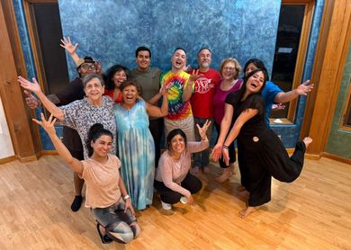 A group of people are posing for a picture in a room.