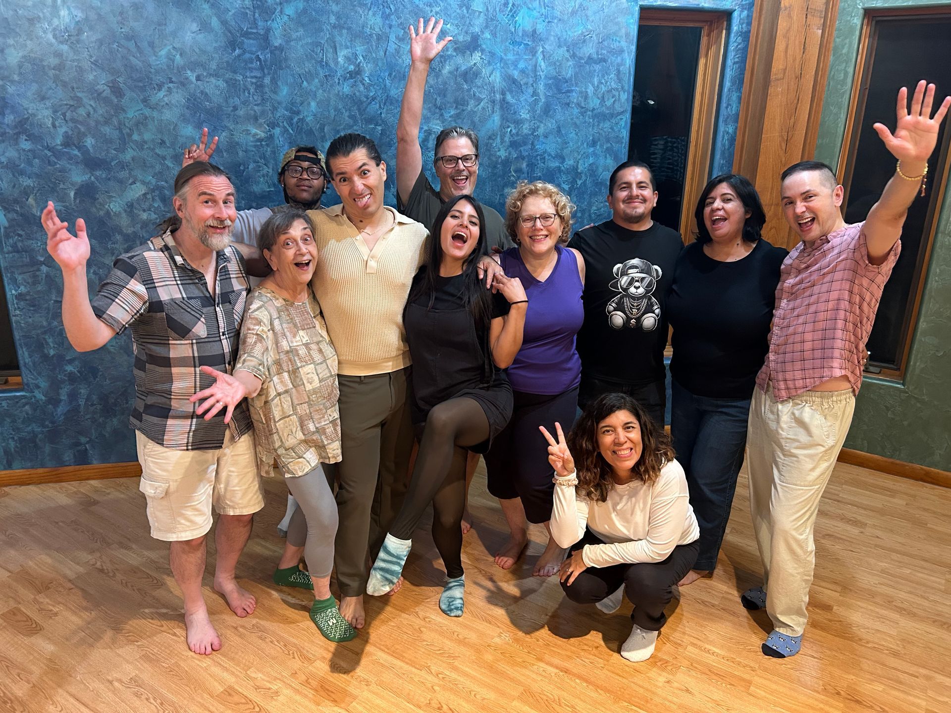 A group of people are posing for a picture in a room.