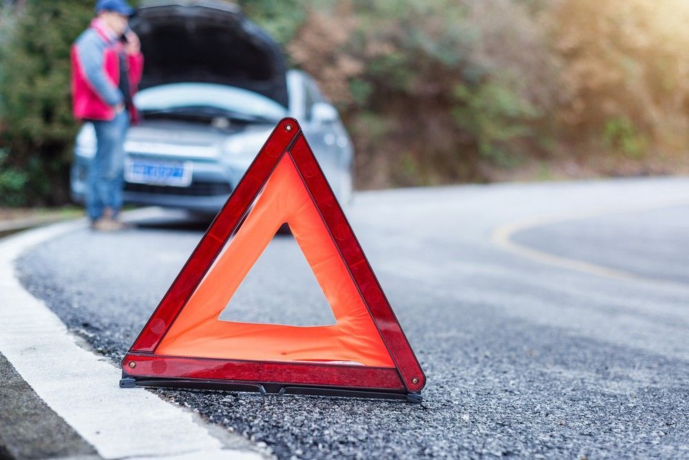 A Man is Standing Next to a Broken Down Car — Payton Civil Products in Wilsonton, QLD