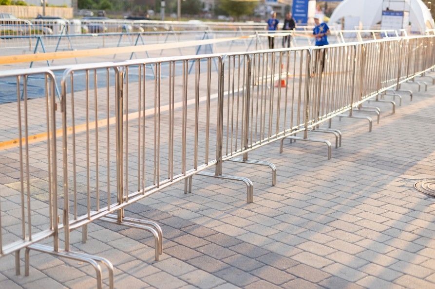 A Row of Stainless Steel Barriers on a Brick Sidewalk — Payton Civil Products in Warwick, QLD
