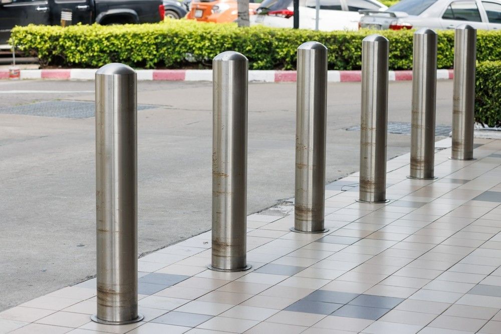 A Row of Stainless Steel Poles on a Sidewalk — Payton Civil Products in Roma, QLD