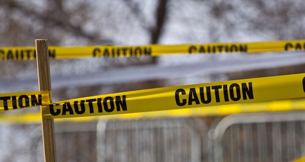 A Close Up of a Yellow Caution Tape on a Fence — Payton Civil Products in Wilsonton, QLD