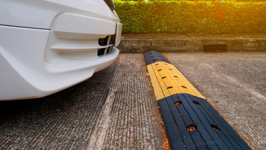 A White Car is Parked Next to a Yellow and Black Speed Bump — Payton Civil Products in Dalby, QLD