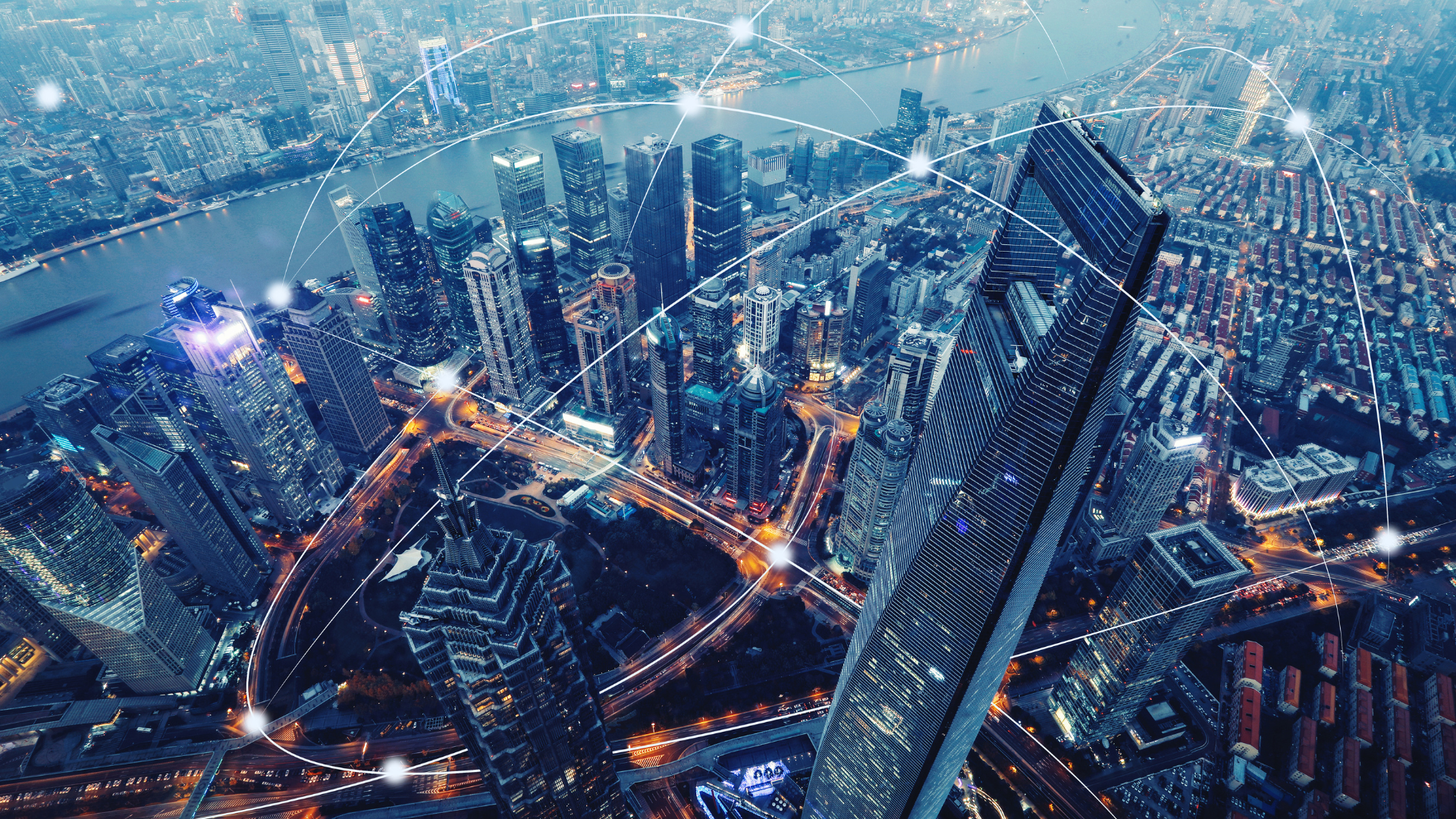 Cityscape at night, interconnected network lines overlaying buildings, symbolizing technology and connectivity.
