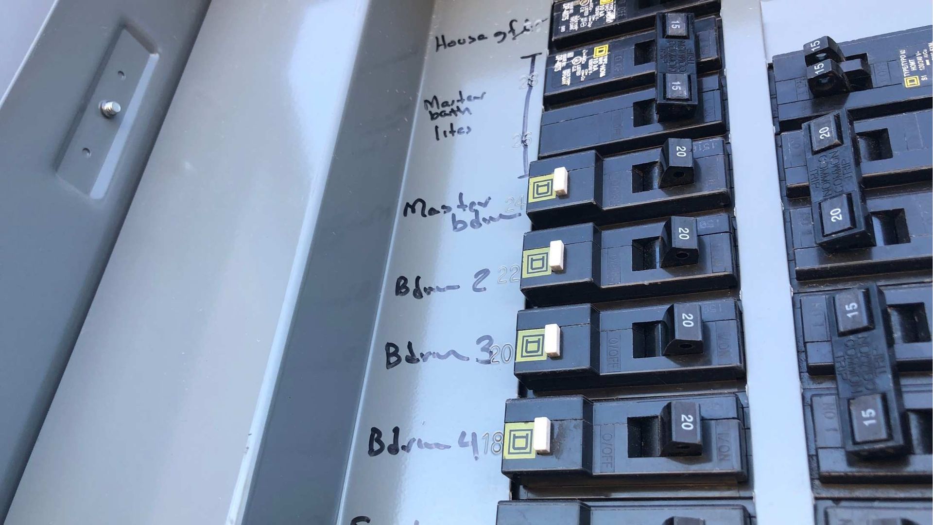 A close up of a electrical panel with labels on it