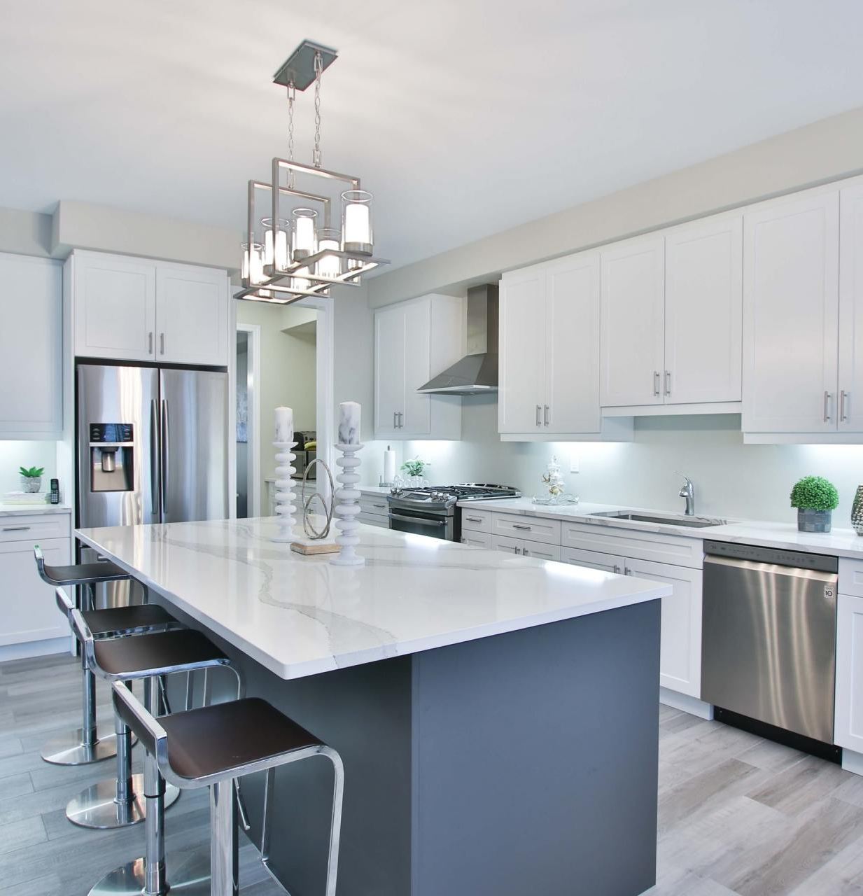 A kitchen with white cabinets and stainless steel appliances