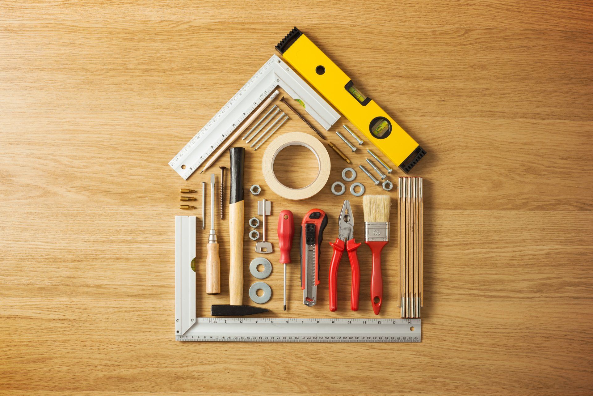 A house made out of tools on a wooden table.