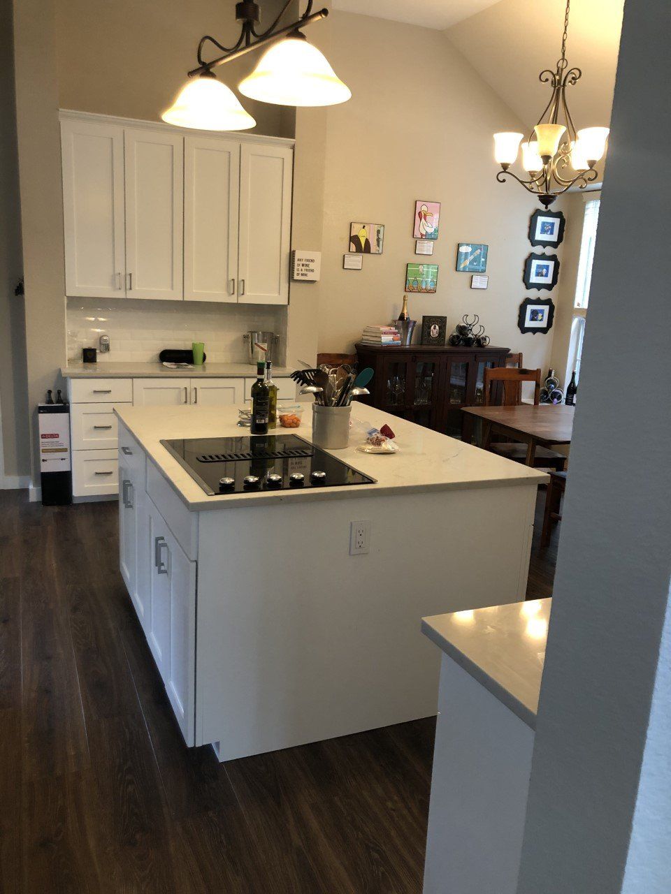 A kitchen with white cabinets and a large island