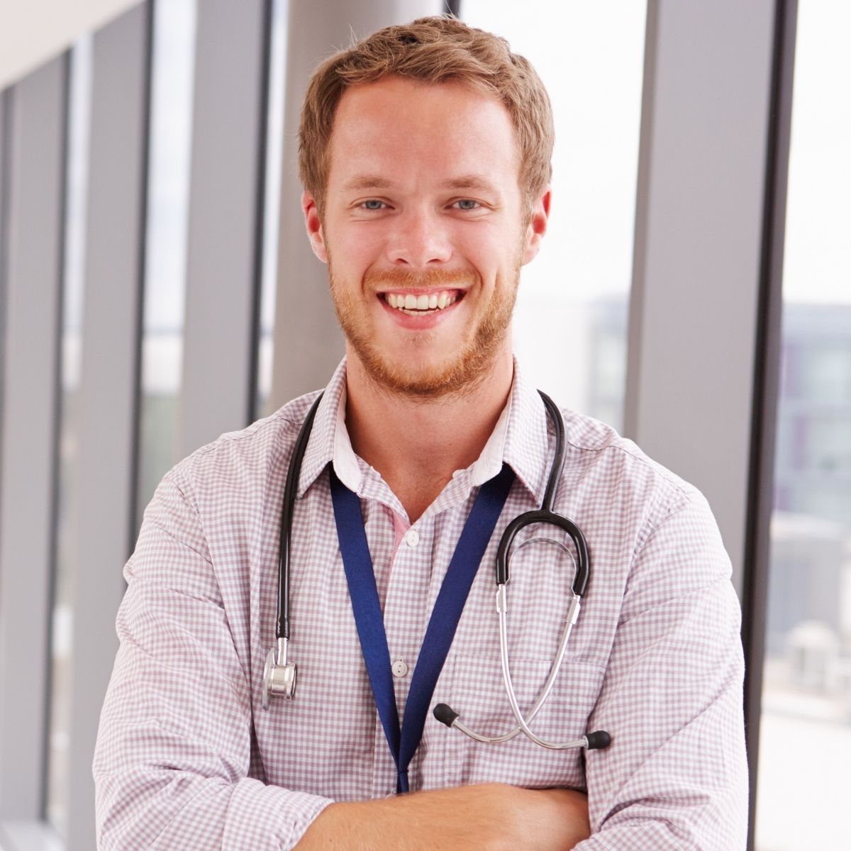 A smiling doctor with a stethoscope around his neck