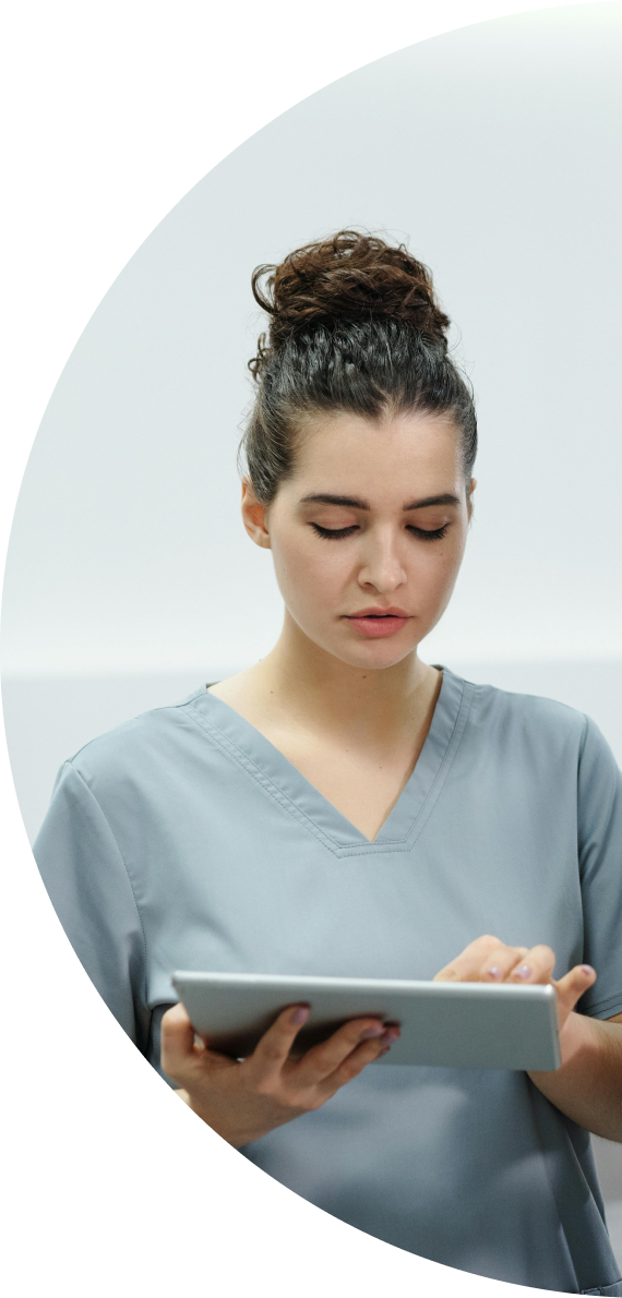 A nurse is using a tablet computer in a hospital.